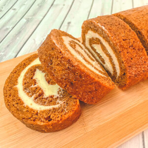 Image of Pumpkin Roll sliced on wooden cutting board